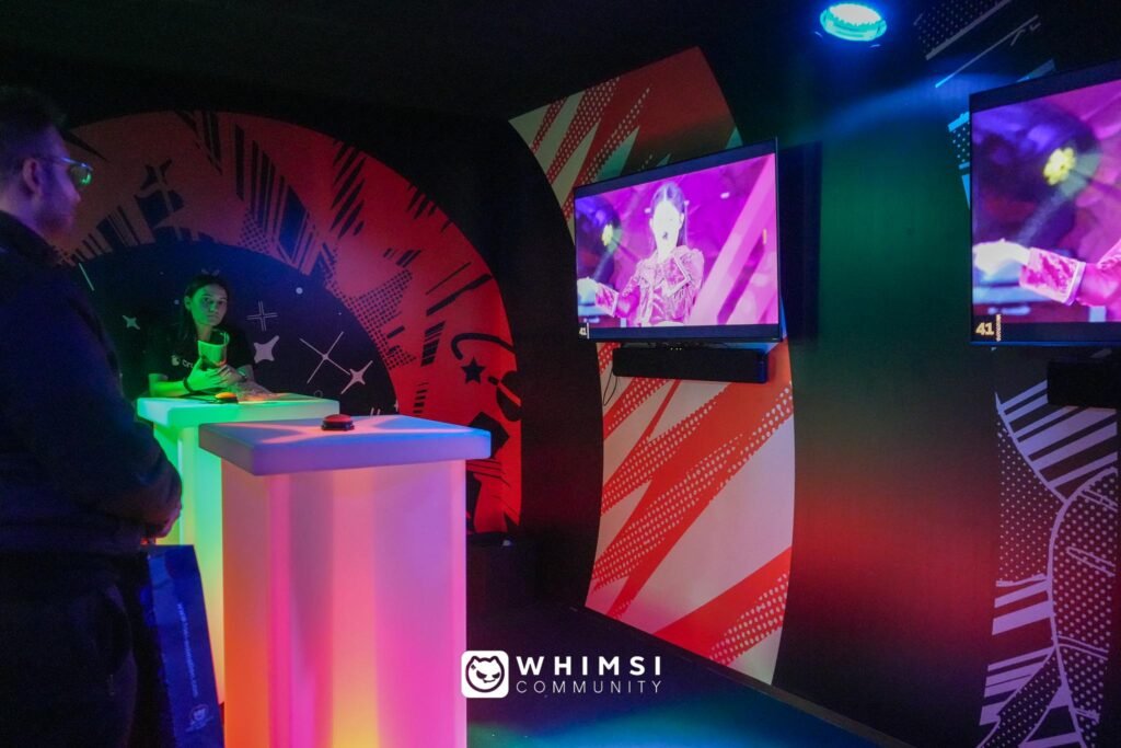 Area quiz multimediale alla Lucca Comics & Games 2024 con schermi e pulsanti colorati.